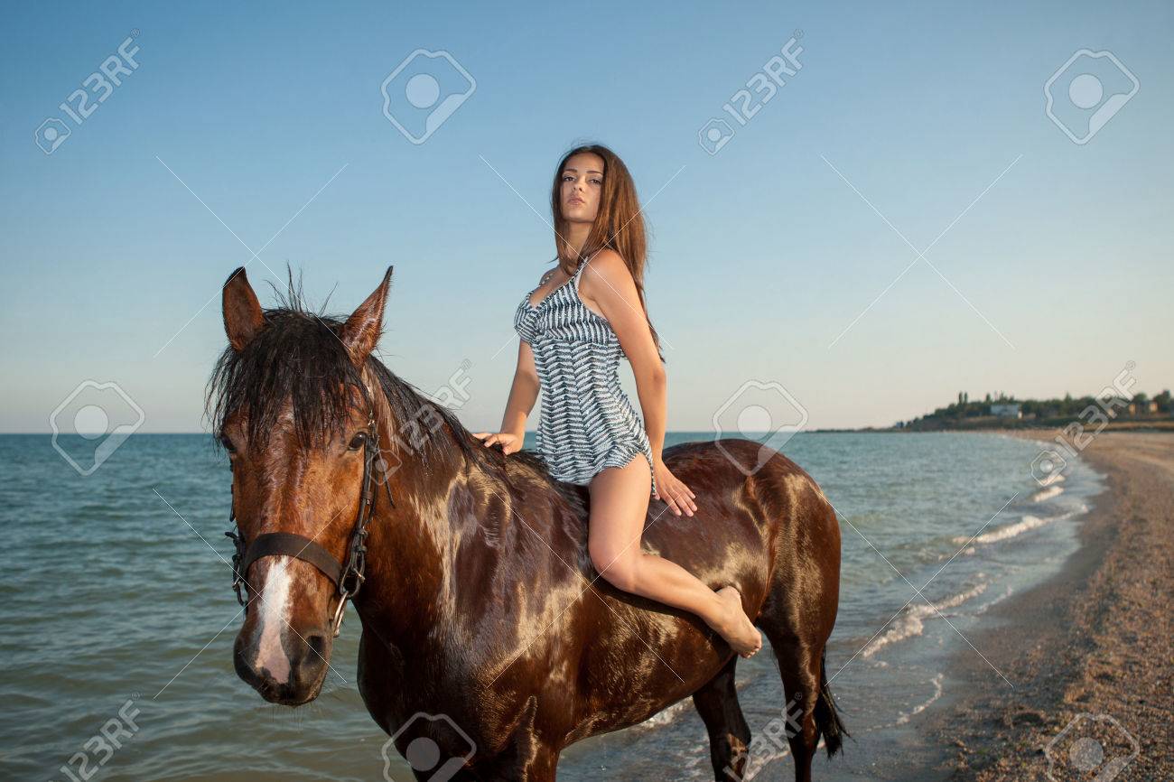 Woman on horse. Young beautiful woman evening beach horse ride - 31344121