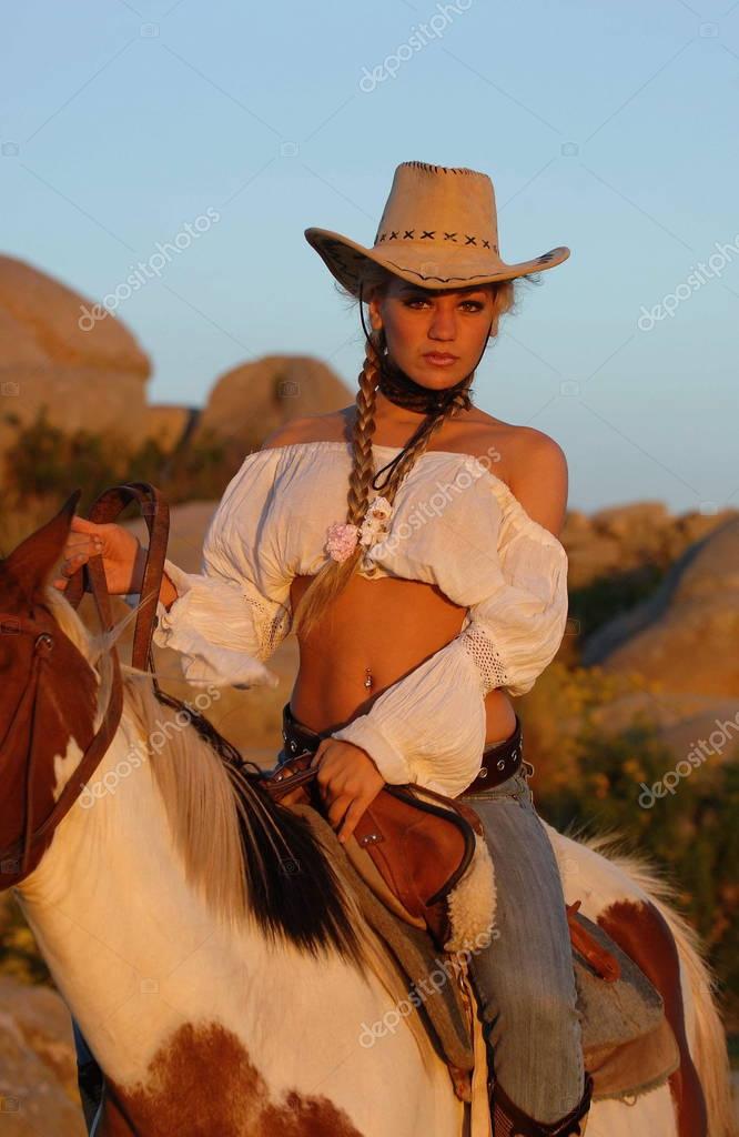 Sexy girl riding a horse — Stock Photo © Angelitush #129230376